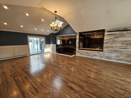 Chandelier, Empty room, Fireplace, Interior, Recessed Lighting, Wood Texture Flooring, Wooden Walls