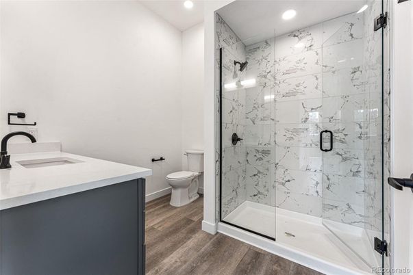 Bathroom, Glass Shower, Interior, Marble Walls, Recessed Lighting, Wood Texture Flooring