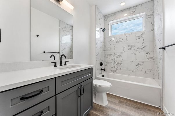 Bathroom, Dual Sink Vanities, Interior, Marble Walls, Recessed Lighting, Wood Texture Flooring
