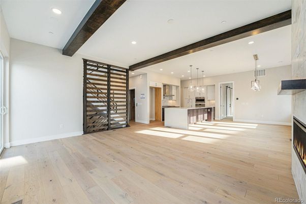 Empty room, Fireplace, Interior, Kitchen, Pendant Lights, Recessed Lighting, Stainless Steel Appliances, Wooden Beams, Wood Texture Flooring