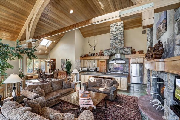 Chandelier, Dining room, Fireplace, Interior, Kitchen, Living room, Pendant Lights, Recessed Lighting, Stainless Steel Appliances, Wooden Beams, Wooden Ceilings