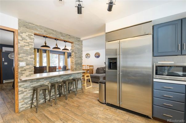 Interior, Kitchen, Pendant Lights, Stainless Steel Appliances, Stone Walls, Wood Texture Flooring