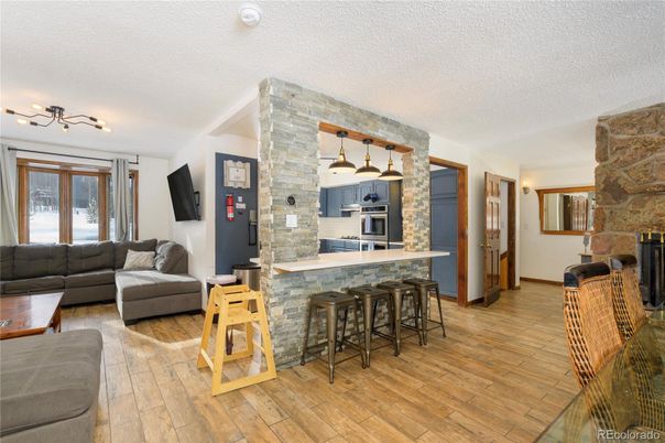 Interior, Kitchen, Living room, Pendant Lights, Stainless Steel Appliances, Stone Walls, Wood Texture Flooring