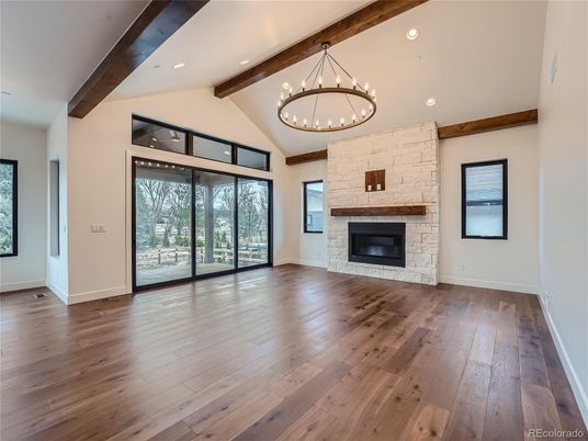 Empty room, Fireplace, Interior, Pendant Lights, Recessed Lighting, Stone Walls, Wooden Beams, Wood Texture Flooring
