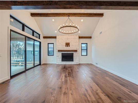 Chandelier, Empty room, Fireplace, Interior, Recessed Lighting, Stone Walls, Wooden Beams, Wood Texture Flooring