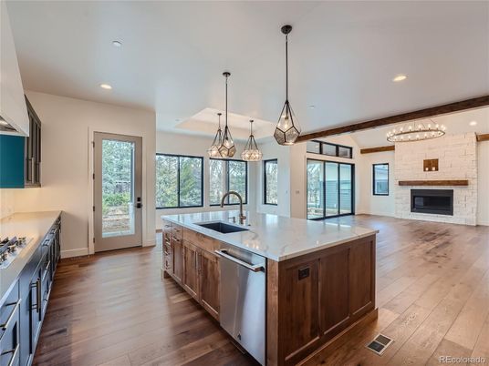 Chandelier, Fireplace, Interior, Kitchen, Pendant Lights, Recessed Lighting, Stainless Steel Appliances, Wood Texture Flooring