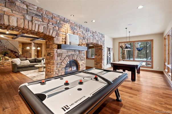 Billiard Table, Fireplace, Game Room, Interior, Pendant Lights, Recessed Lighting, Stone Walls, Wood Texture Flooring