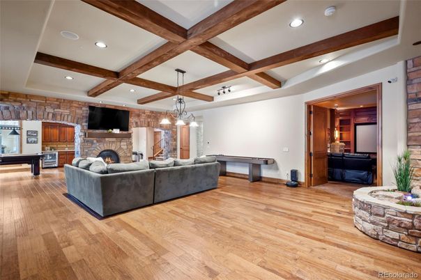Billiard Table, Fireplace, Game Room, Interior, Living room, Pendant Lights, Recessed Lighting, Stone Walls, Wooden Beams, Wood Texture Flooring