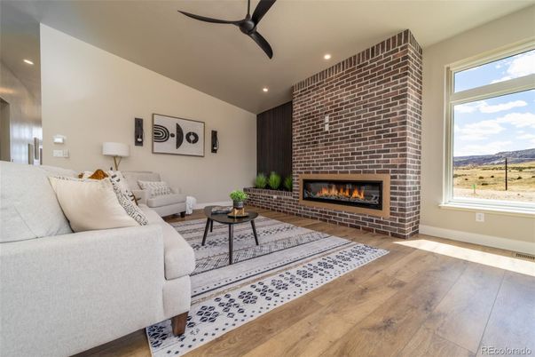 Fireplace, Interior, Living room, Recessed Lighting, Stone Walls, Wood Texture Flooring