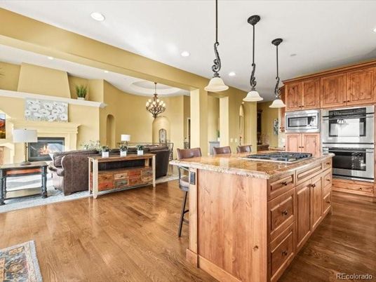 Chandelier, Dining room, Fireplace, Interior, Kitchen, Living room, Pendant Lights, Recessed Lighting, Stainless Steel Appliances, Wood Texture Flooring