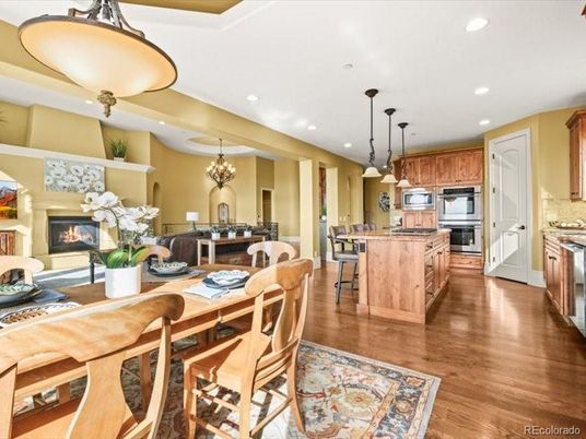 Chandelier, Dining room, Fireplace, Interior, Kitchen, Pendant Lights, Recessed Lighting, Stainless Steel Appliances, Wood Texture Flooring