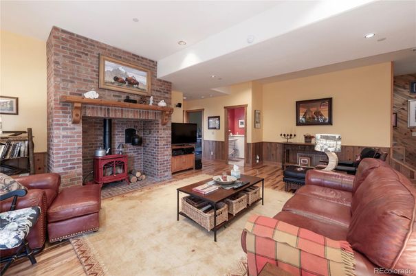 Fireplace, Interior, Living room, Recessed Lighting, Stone Walls, Wood Texture Flooring
