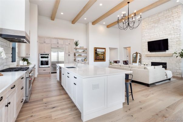 Chandelier, Fireplace, Interior, Kitchen, Living room, Recessed Lighting, Stainless Steel Appliances, Stone Walls, Wooden Beams, Wood Texture Flooring