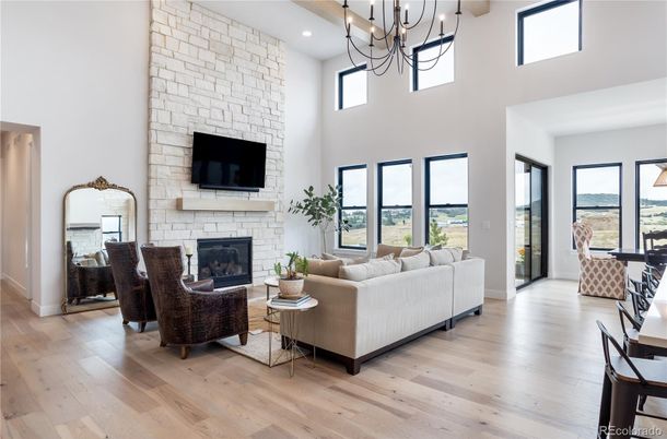 Chandelier, Fireplace, Interior, Living room, Recessed Lighting, Stone Walls, Wood Texture Flooring