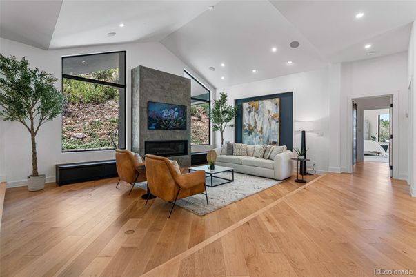 Fireplace, Interior, Living room, Recessed Lighting, Stone Walls, Wood Texture Flooring
