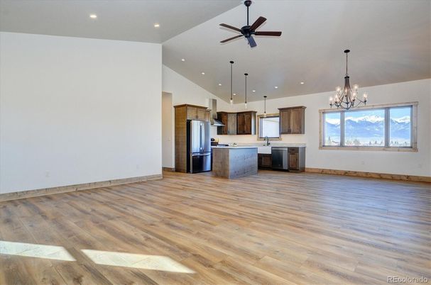 Chandelier, Empty room, Interior, Kitchen, Pendant Lights, Recessed Lighting, Stainless Steel Appliances, Wood Texture Flooring