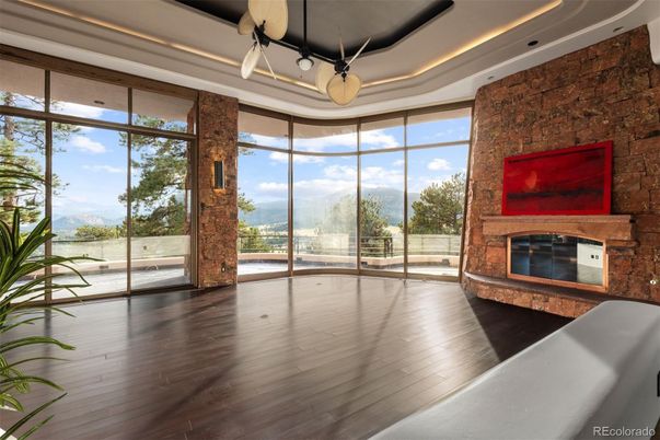 Empty room, Fireplace, Interior, Recessed Lighting, Stone Walls, Wood Texture Flooring