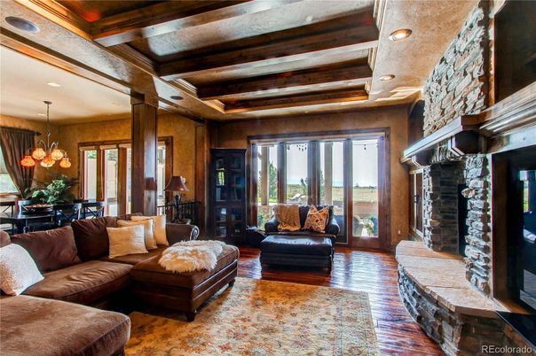 Chandelier, Dining room, Fireplace, Interior, Living room, Recessed Lighting, Stone Walls, Wooden Beams, Wood Texture Flooring