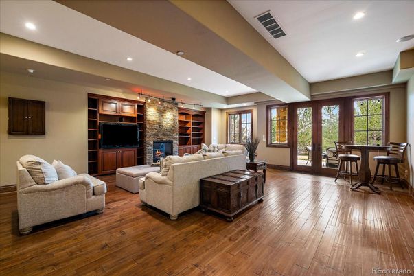 Dining room, Fireplace, Interior, Living room, Recessed Lighting, Stone Walls, Wood Texture Flooring