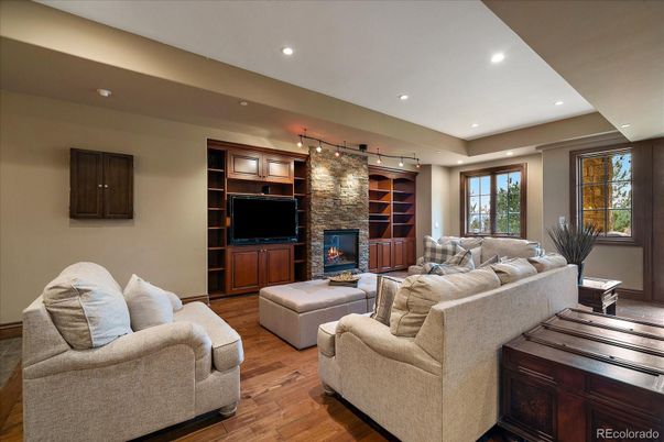 Fireplace, Interior, Living room, Recessed Lighting, Stone Walls, Wood Texture Flooring