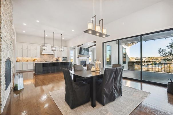 Dining room, Fireplace, Interior, Kitchen, Pendant Lights, Recessed Lighting, Stainless Steel Appliances, Stone Walls, Wood Texture Flooring