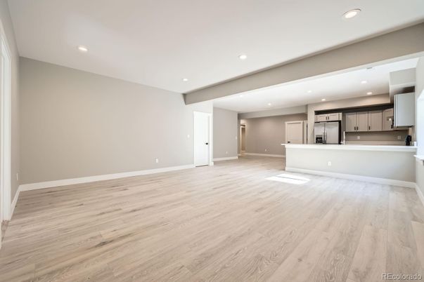 Empty room, Interior, Kitchen, Recessed Lighting, Stainless Steel Appliances, Wood Texture Flooring