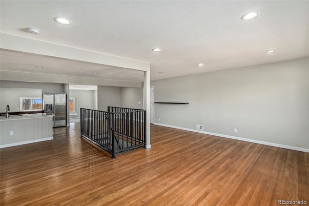 Empty room, Interior, Kitchen, Recessed Lighting, Stainless Steel Appliances, Wood Texture Flooring