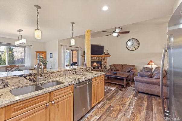 Fireplace, Interior, Kitchen, Living room, Pendant Lights, Recessed Lighting, Stainless Steel Appliances, Wood Texture Flooring
