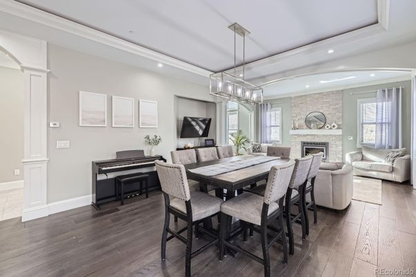 Chandelier, Dining room, Fireplace, Interior, Living room, Pendant Lights, Piano, Recessed Lighting, Stone Walls, Wood Texture Flooring
