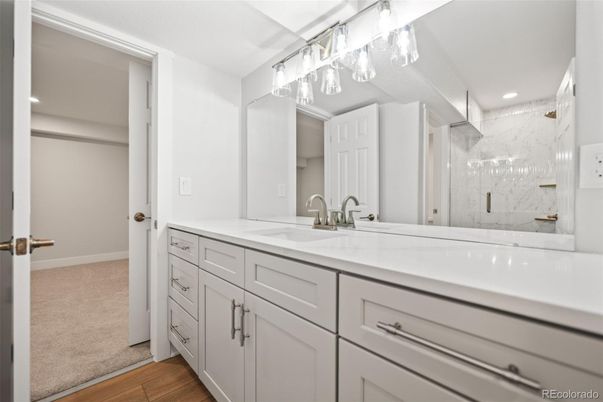 Bathroom, Dual Sink Vanities, Glass Shower, Interior, Marble Walls, Recessed Lighting, Wood Texture Flooring