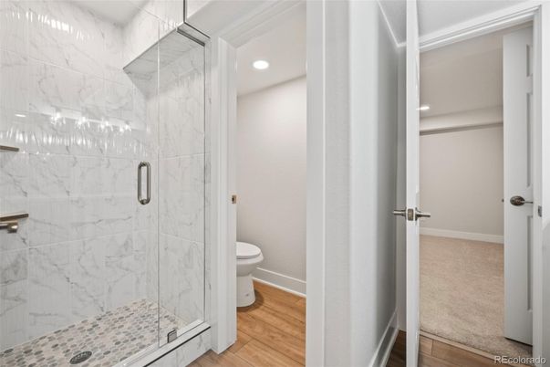 Bathroom, Glass Shower, Interior, Marble Walls, Recessed Lighting, Wood Texture Flooring