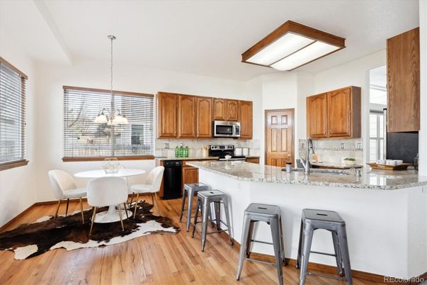 Chandelier, Dining room, Interior, Kitchen, Pendant Lights, Stainless Steel Appliances, Wood Texture Flooring
