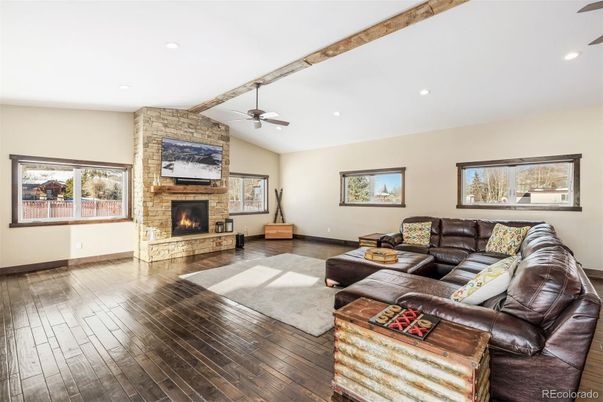 Fireplace, Interior, Living room, Recessed Lighting, Stone Walls, Wood Texture Flooring