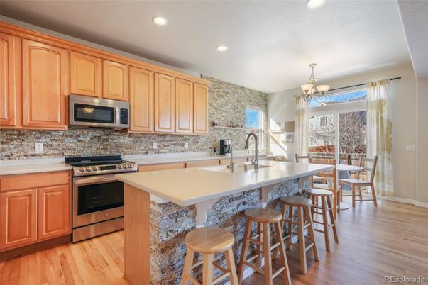 Chandelier, Dining room, Interior, Kitchen, Recessed Lighting, Stainless Steel Appliances, Wood Texture Flooring