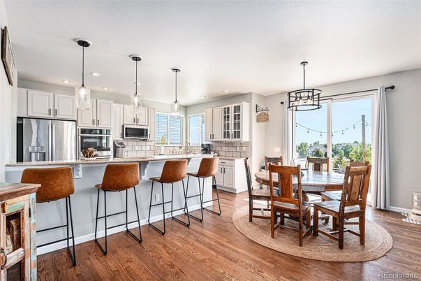 Dining room, Interior, Kitchen, Pendant Lights, Recessed Lighting, Stainless Steel Appliances, Wood Texture Flooring
