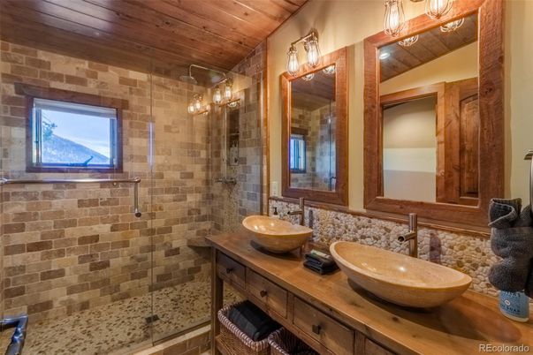 Bathroom, Dual Sink Vanities, Glass Shower, Interior, Stone Walls, Wooden Ceilings