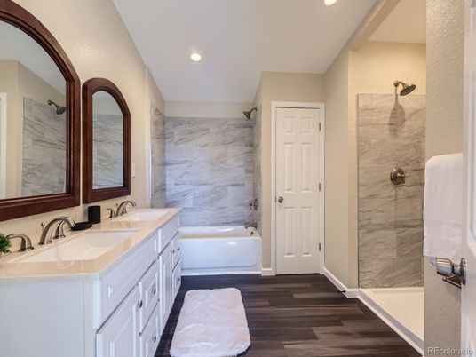 Bathroom, Dual Sink Vanities, Glass Shower, Interior, Marble Walls, Recessed Lighting, Wood Texture Flooring