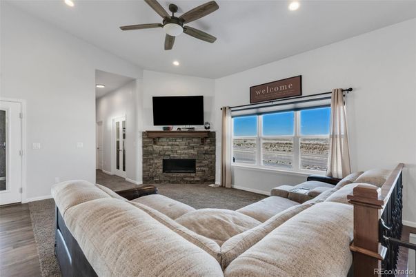 Fireplace, Interior, Living room, Recessed Lighting, Stone Walls, Wood Texture Flooring