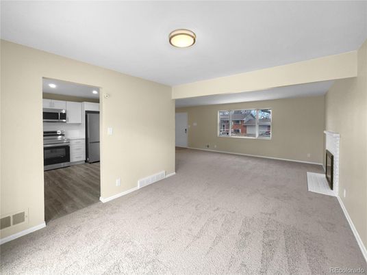 Empty room, Fireplace, Interior, Kitchen, Recessed Lighting, Stainless Steel Appliances, Wood Texture Flooring