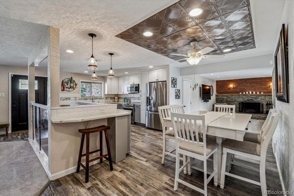 Dining room, Fireplace, Interior, Kitchen, Pendant Lights, Recessed Lighting, Stainless Steel Appliances, Stone Walls, Wood Texture Flooring