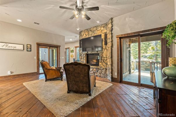 Fireplace, Interior, Living room, Recessed Lighting, Stone Walls, Wood Texture Flooring