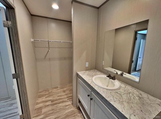 Bathroom, Dual Sink Vanities, Interior, Recessed Lighting, Walk-in Closets, Wood Texture Flooring