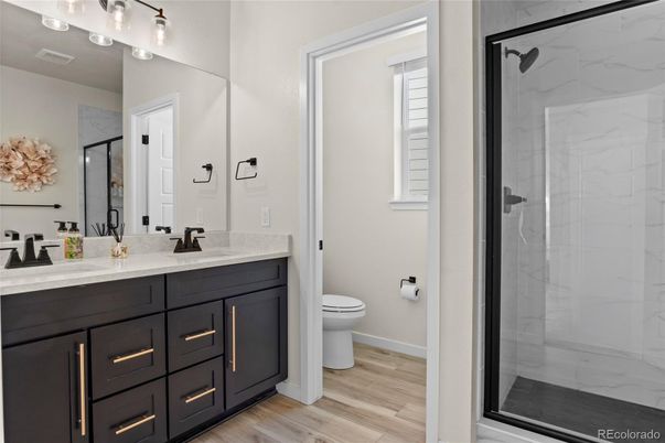 Bathroom, Dual Sink Vanities, Glass Shower, Interior, Marble Walls, Wood Texture Flooring