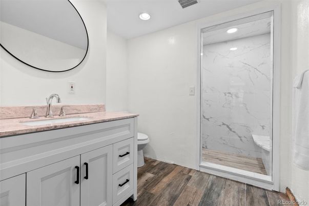 Bathroom, Glass Shower, Interior, Marble Walls, Recessed Lighting, Wood Texture Flooring