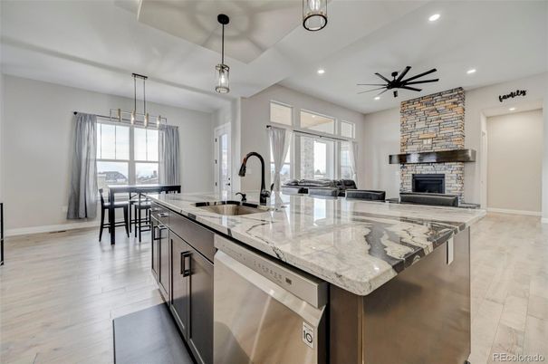 Dining room, Fireplace, Interior, Kitchen, Pendant Lights, Recessed Lighting, Stainless Steel Appliances, Stone Walls, Wood Texture Flooring