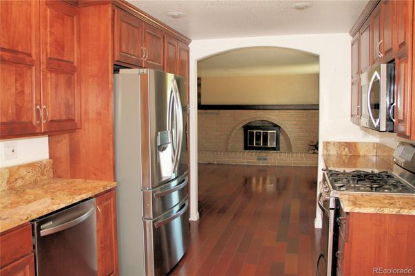 Fireplace, Interior, Kitchen, Stainless Steel Appliances, Stone Walls, Wood Texture Flooring