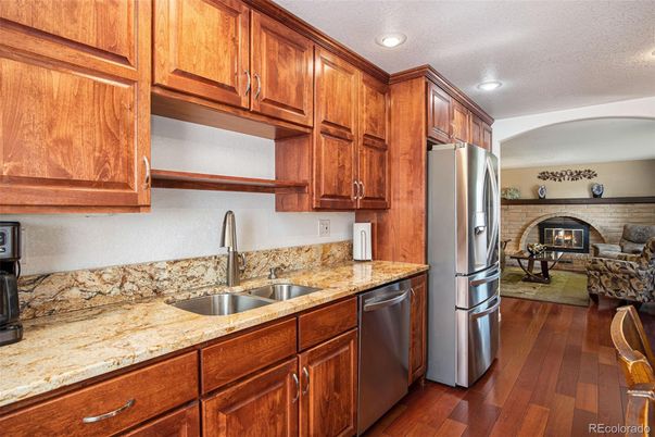 Dining room, Fireplace, Interior, Kitchen, Recessed Lighting, Stainless Steel Appliances, Stone Walls, Wood Texture Flooring