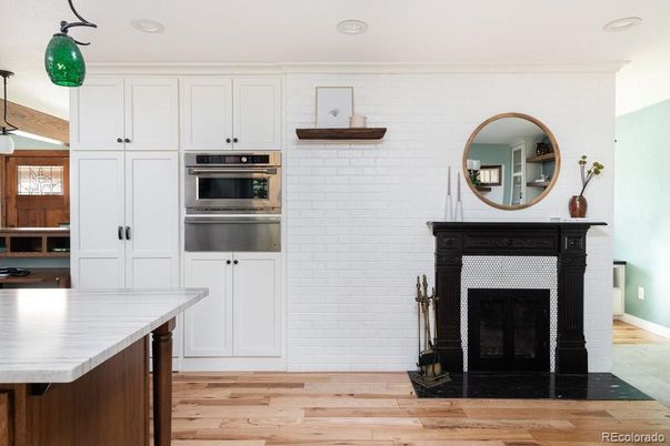 Fireplace, Interior, Kitchen, Recessed Lighting, Stainless Steel Appliances, Wood Texture Flooring