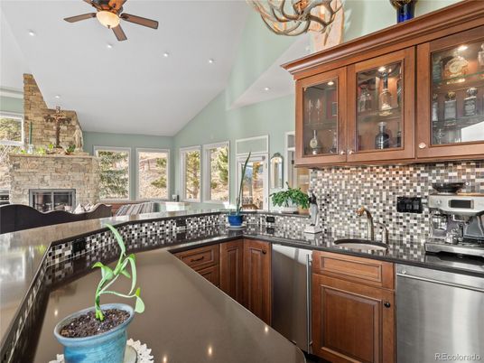 Fireplace, Interior, Kitchen, Recessed Lighting, Stainless Steel Appliances, Stone Walls
