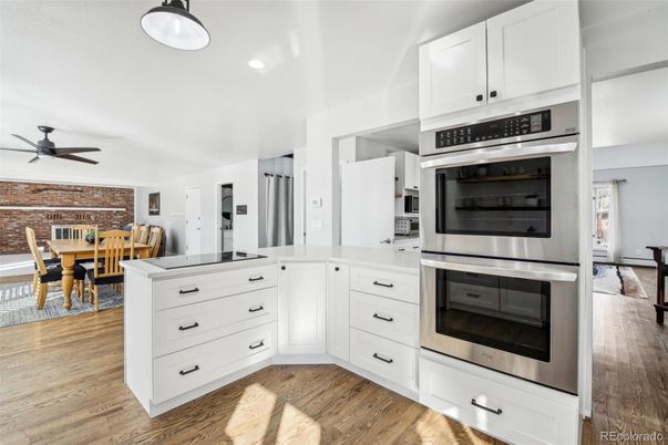Dining room, Interior, Kitchen, Recessed Lighting, Stainless Steel Appliances, Stone Walls, Wood Texture Flooring